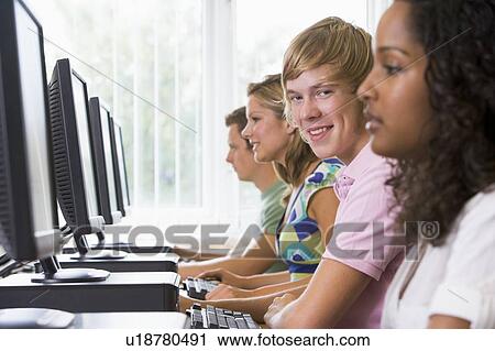 Four people sitting at computer terminals (selective focus/high key) View Large Photo Image Stock Image - Four people sitting at computer terminals (selective focus/high key). Fotosearch