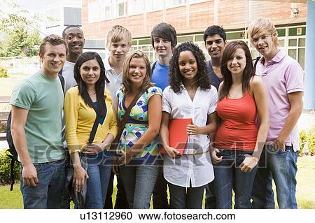 Stock Image - Group of students outdoors looking at camera smiling. Fotosearch