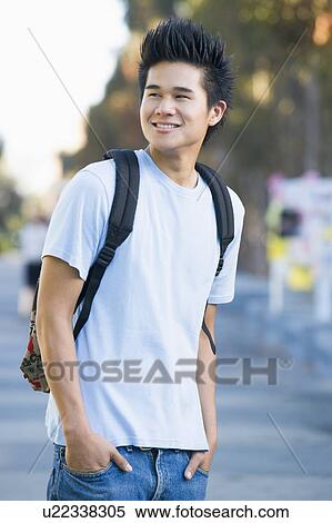 Man standing outdoors smiling (selective focus) View Large Photo Image Stock Photography - Man standing outdoors smiling (selective focus). Fotosearch