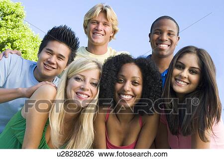 Six people outdoors huddling over camera View Large Photo Image Stock Photograph - Six people outdoors huddling over camera. Fotosearch