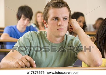 Stock Photograph - Student in class bored (selective focus). Fotosearch
