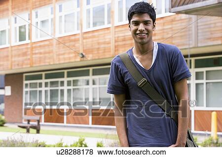 Student standing outdoors smiling View Large Photo Image Stock Photo - Student standing outdoors smiling. Fotosearch
