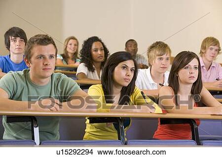 Picture - Students in class paying attention and taking notes (depth of field). Fotosearch