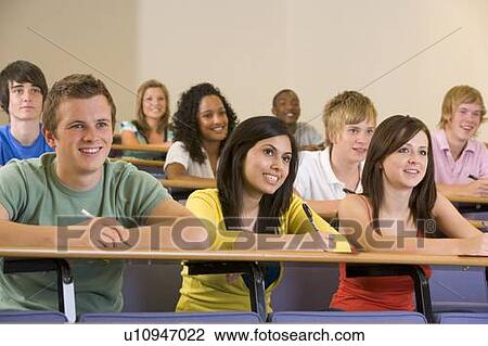 Stock Image - Students in class paying attention and taking notes (depth of field). Fotosearch