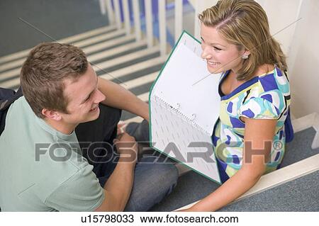 Two students sitting on staircase with notebooks (selective focus) View Large Photo Image Stock Image - Two students sitting on staircase with notebooks (selective focus). Fotosearch