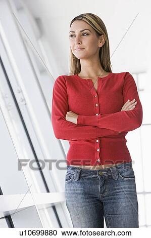 Stock Image - Woman standing in corridor. Fotosearch