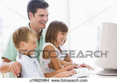 Picture - Man and two young children in home office with computer smiling. Fotosearch