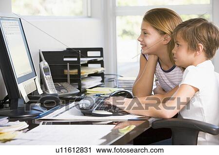 Young boy and young girl in home office with computer smiling View Large Photo Image Stock Image - Young boy and young girl in home office with computer smiling. Fotosearch