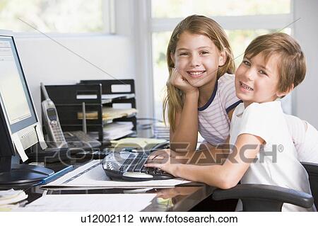 Young boy and young girl in home office with computer smiling View Large Photo Image Stock Image - Young boy and young girl in home office with computer smiling. Fotosearch