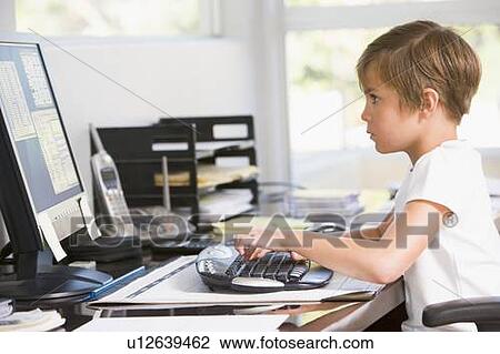 Young boy in home office with computer typing View Large Photo Image Stock Image - Young boy in home office with computer typing. Fotosearch