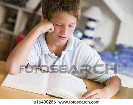 Young Boy Reading A Book In His Room View Large Photo Image Stock Photography - Young Boy Reading A Book In His Room. Fotosearch