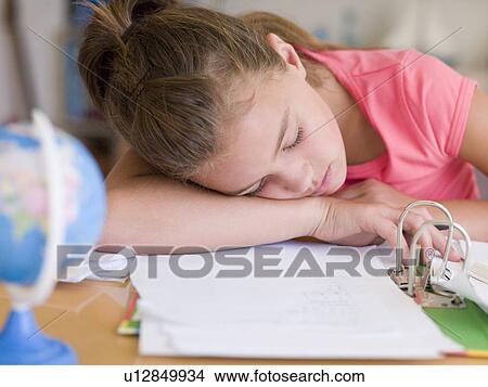 Picture - Young Girl Asleep On Her Homework. Fotosearch