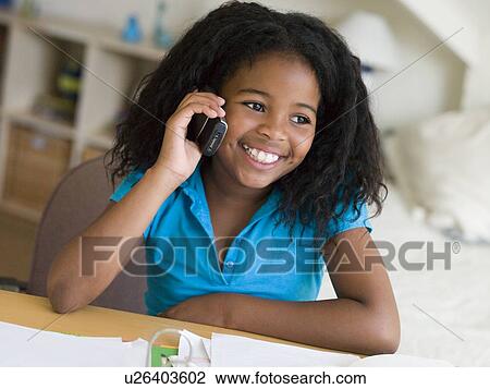 Young Girl Distracted From Her Homework, Talking On A Cellphone View Large Photo Image Stock Image - Young Girl Distracted From Her Homework, Talking On A Cellphone. Fotosearch