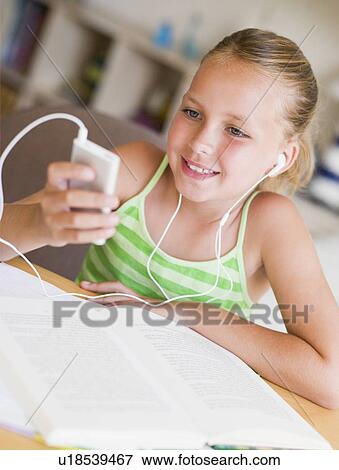 Young Girl Distracted From Her Homework, Playing With An MP3 Player View Large Photo Image Stock Photo - Young Girl Distracted From Her Homework, Playing With An MP3 Player. Fotosearch