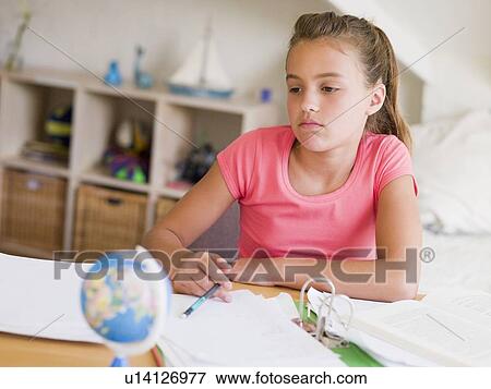 Stock Photo - Young Girl Doing Her Homework. Fotosearch