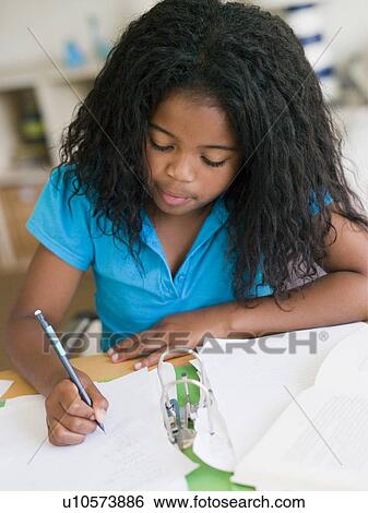 Stock Photograph - Young Girl Doing Homework. Fotosearch