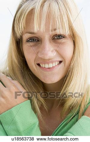 Blonde woman in a green sweater posing outdoors View Large Photo Image Stock Photo - Blonde woman in a green sweater posing outdoors. Fotosearch