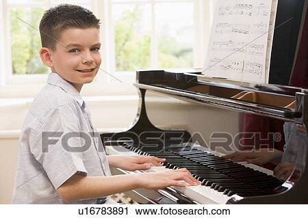 Stock Image - Boy Playing Piano. Fotosearch