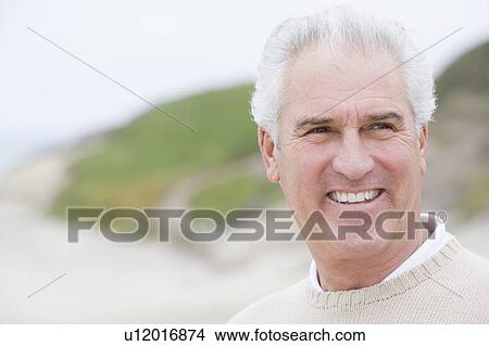 Man at the beach smiling View Large Photo Image Picture - Man at the beach smiling. Fotosearch