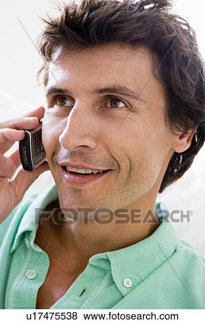 Man using cellular phone and smiling View Large Photo Image Stock Photo - Man using cellular phone and smiling. Fotosearch