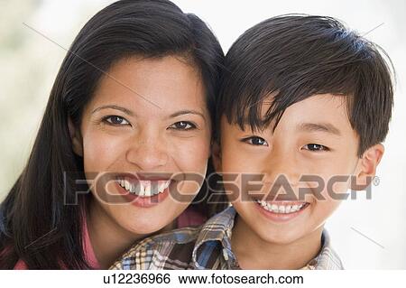 Stock Photograph - Woman and young boy smiling. Fotosearch