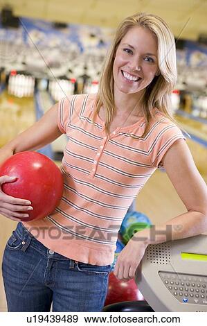 Stock Photo - Woman at a bowling lane. Fotosearch