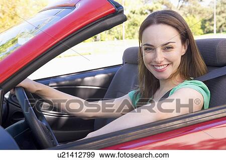 Woman in convertible car smiling View Large Photo Image Stock Photo - Woman in convertible car smiling. Fotosearch