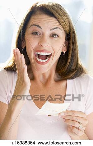 Woman with winning lottery ticket excited and smiling View Large Photo Image Picture - Woman with winning lottery ticket excited and smiling. Fotosearch