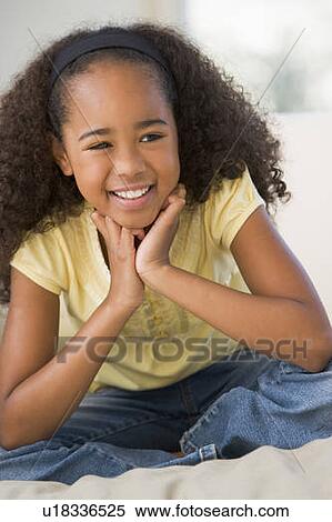 Young Girl Sitting On A Sofa At Home View Large Photo Image Stock Photography - Young Girl Sitting On A Sofa At Home. Fotosearch