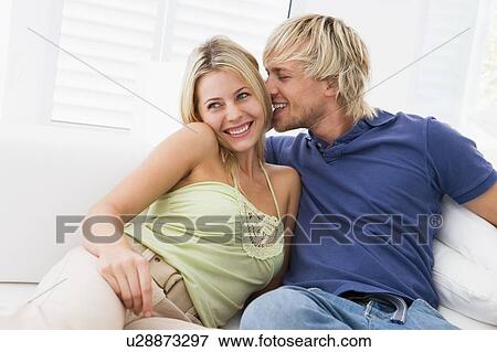 Couple in living room kissing and smiling View Large Photo Image Stock Photo - Couple in living room kissing and smiling. Fotosearch
