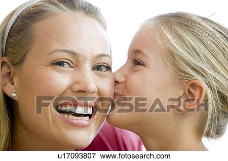Young girl kissing smiling woman View Large Photo Image Stock Photo - Young girl kissing smiling woman. Fotosearch