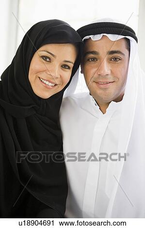Stock Image - Couple indoors smiling (high key). Fotosearch