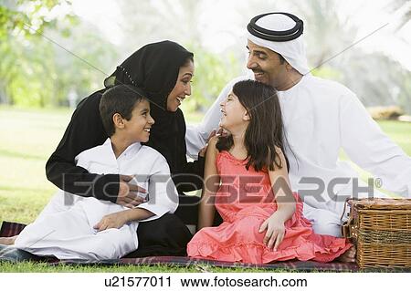 Family outdoors in park having a picnic and smiling (selective focus) View Large Photo Image Stock Image - Family outdoors in park having a picnic and smiling (selective focus). Fotosearch