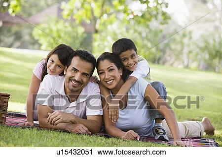 Family outdoors in park with picnic smiling (selective focus) View Large Photo Image Stock Image - Family outdoors in park with picnic smiling (selective focus). Fotosearch