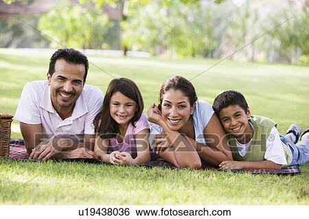 Family outdoors in park with picnic smiling (selective focus) View Large Photo Image Stock Photograph - Family outdoors in park with picnic smiling (selective focus). Fotosearch