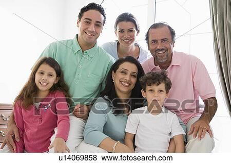 Family sitting in living room smiling (high key) View Large Photo Image Stock Photo - Family sitting in living room smiling (high key). Fotosearch