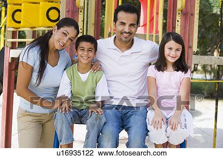 Family sitting on playground structure smiling (selective focus) View Large Photo Image Stock Image - Family sitting on playground structure smiling (selective focus). Fotosearch