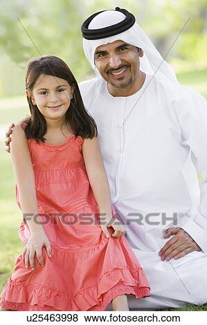 Man and young girl outdoors in a park smiling (selective focus) View Large Photo Image Stock Photo - Man and young girl outdoors in a park smiling (selective focus). Fotosearch