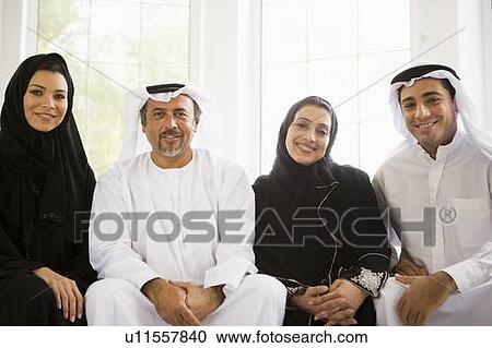 Two couples sitting in living room smiling (high key/selective focus) View Large Photo Image Stock Image - Two couples sitting in living room smiling (high key/selective focus). Fotosearch