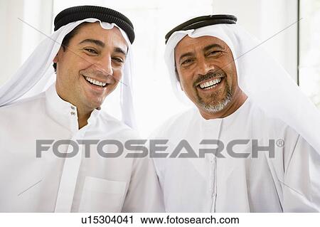 Two men sitting indoors smiling (high key) View Large Photo Image Stock Image - Two men sitting indoors smiling (high key). Fotosearch
