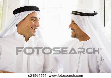 Two men sitting indoors talking and smiling (high key) View Large Photo Image Stock Image - Two men sitting indoors talking and smiling (high key). Fotosearch