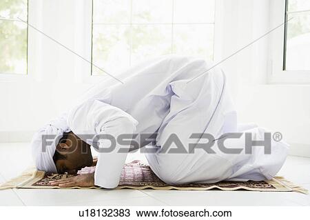 Man indoors praying on mat (high key) View Large Photo Image Stock Image - Man indoors praying on mat (high key). Fotosearch