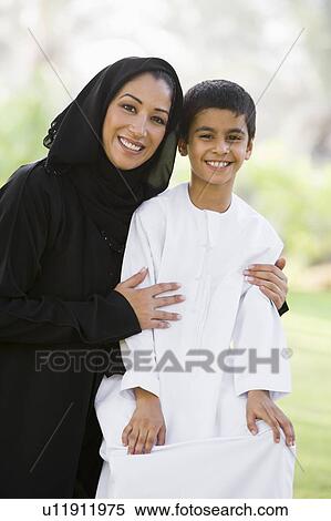 Woman and young boy outdoors in a park smiling (selective focus) View Large Photo Image Stock Photography - Woman and young boy outdoors in a park smiling (selective focus). Fotosearch