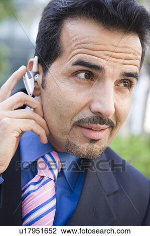 Businessman outdoors wearing headset (selective focus) View Large Photo Image Stock Image - Businessman outdoors wearing headset (selective focus). Fotosearch