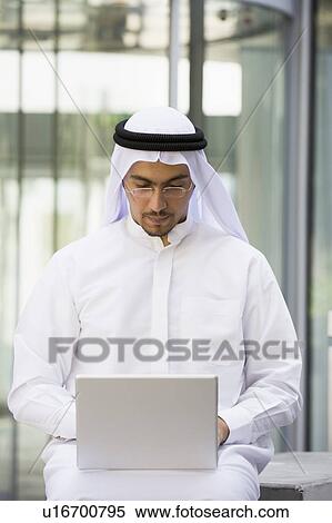 Businessman sitting outdoors with laptop by building (selective focus) View Large Photo Image Stock Photography - Businessman sitting outdoors with laptop by building (selective focus). Fotosearch
