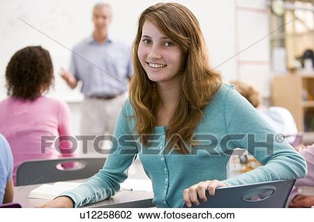 Female student with other students in classroom View Large Photo Image Stock Image - Female student with other students in classroom. Fotosearch