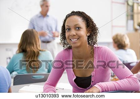 Female student with other students in classroom View Large Photo Image Stock Image - Female student with other students in classroom. Fotosearch