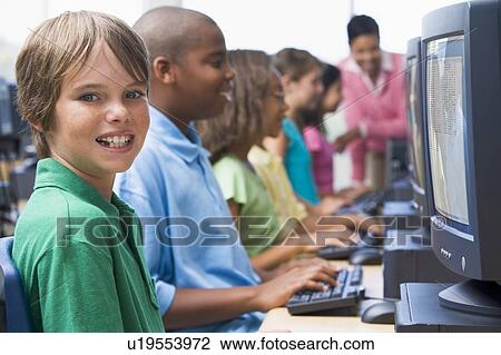 Six children at computer terminals with teacher in background (depth of field/high key) View Large Photo Image Stock Image - Six children at computer terminals with teacher in background (depth of field/high key). Fotosearch