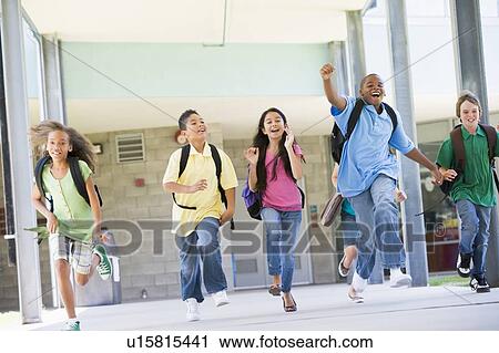 Stock Image - Six students running away from front door of school excited. Fotosearch