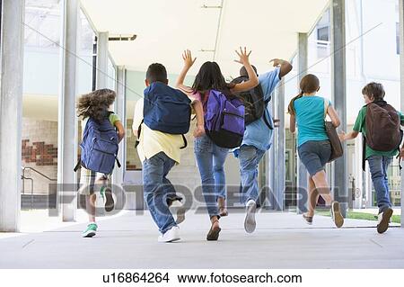 Picture - Six students running to front door of school excited. Fotosearch